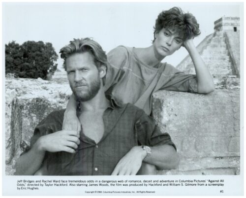 Promotional still of Jeff Bridges and Rachel Ward leaning on a stone wall, a tense moment from the 1984 film Against All Odds (black and white).