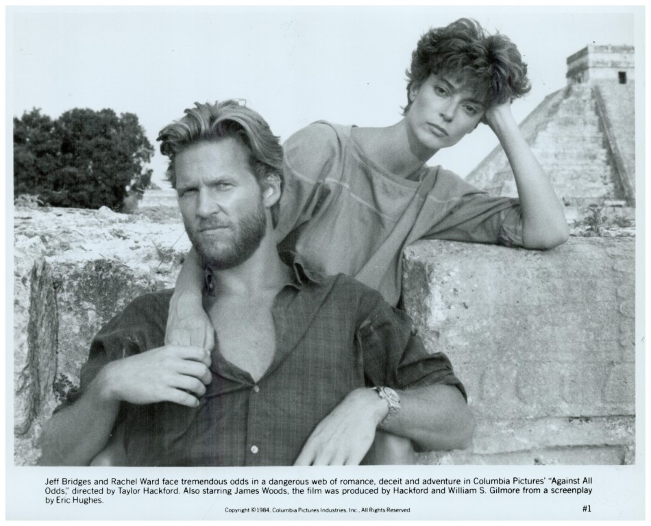 Promotional still of Jeff Bridges and Rachel Ward leaning on a stone wall, a tense moment from the 1984 film Against All Odds (black and white).