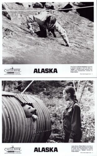 Two black‑and‑white Alaska stills: a climber on rocky terrain; a woman in gear facing a bear from a large ribbed drum.