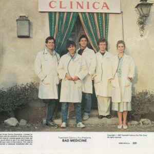 Group of five people in white lab coats standing outside a clinic with green curtains and a red 'CLINICA' sign, a film poster for Bad Medicine.