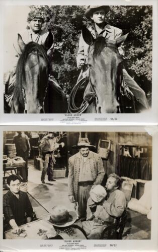 Two cowboys on horseback side by side, wearing hats, in a leafy outdoor setting; film still from Blood Arrow.