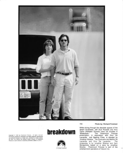 Black-and-white poster for the film Breakdown: a man wearing sunglasses and a woman in a light shirt stand side by side in front of a Jeep, with the movie title and credits at the bottom.