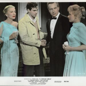 Four adults in a formal living room: a man in a beige trench coat shakes hands with a man in a tuxedo while two women in teal gowns look on.