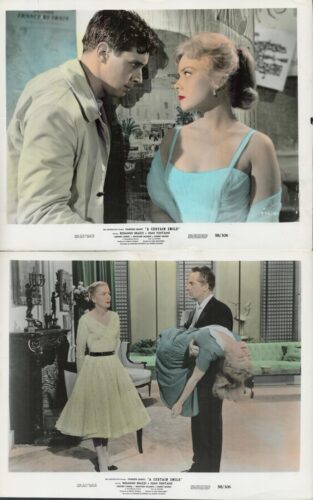 Close-up of a man and a woman gazing at each other; the woman wears a turquoise dress and red lipstick.