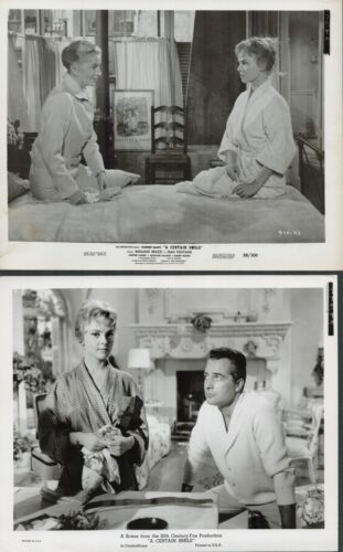 Still from the film A Certain Smile: two women in robes sit on a bed and face each other in a bedroom set.