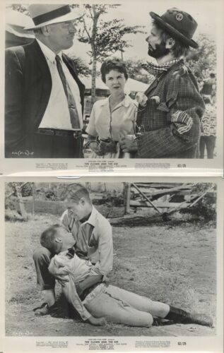 Black-and-white scene: two men in hats and a woman converse outdoors near trees.