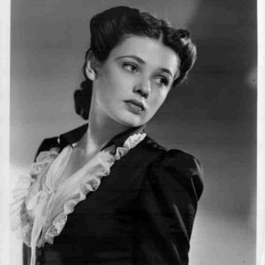 Black-and-white portrait of a young woman in a vintage dress with a lace-trimmed collar, looking to the left.