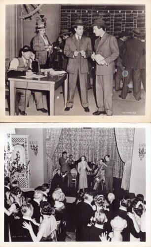 Three men in 1930s suits converse near a clerk at a desk in front of a Belmont Park betting board.