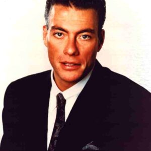 Formal head-and-shoulders portrait of a man in a dark suit and tie, looking at the camera against a light background.