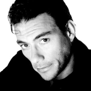 Black-and-white portrait of a man with dark hair, looking slightly to the side with a subtle smile.
