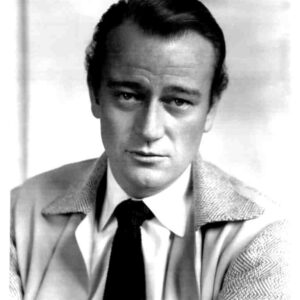 Black-and-white portrait of a man in a suit and tie, looking slightly to the left.