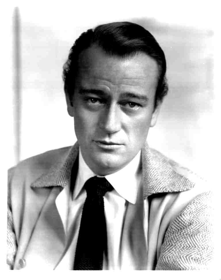 Black-and-white portrait of a man in a suit and tie, looking slightly to the left.