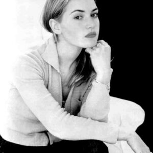 Black-and-white portrait of a woman resting her chin on her hand, wearing a light sweater.