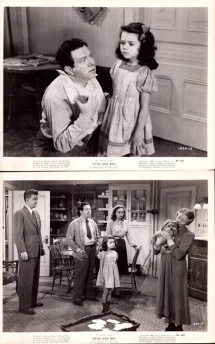 Black-and-white film still: a man with shaving cream on his face kneels near a young girl in a striped dress who watches him.