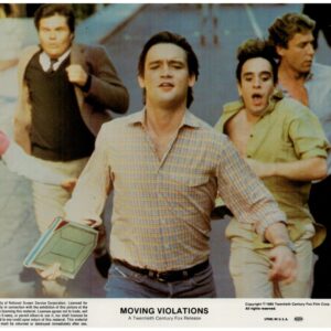 Promo still from the 1985 film Moving Violations: three men run toward the camera on a street, central figure in a plaid shirt carrying a lunchbox, movie title area at bottom.