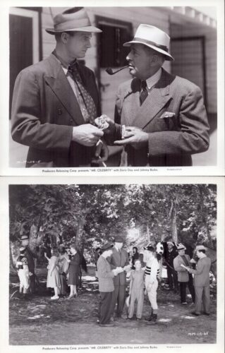 Two men in 1930s suits and fedoras chat on a street; one smokes a pipe while the other holds a small object.