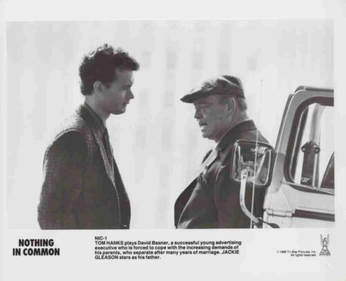 Black-and-white movie poster showing a younger man and an older man talking beside a truck cab; title Nothing in Common visible in bottom-left.