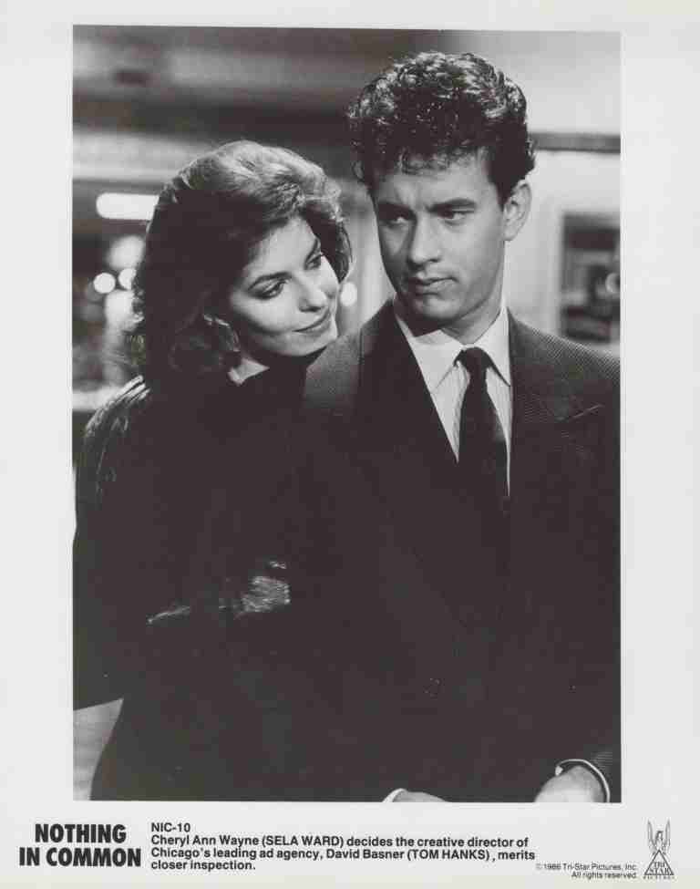 Film poster for 'Nothing in Common' featuring a man in a suit looking to the side while a woman rests her head on his shoulder in a black-and-white image.