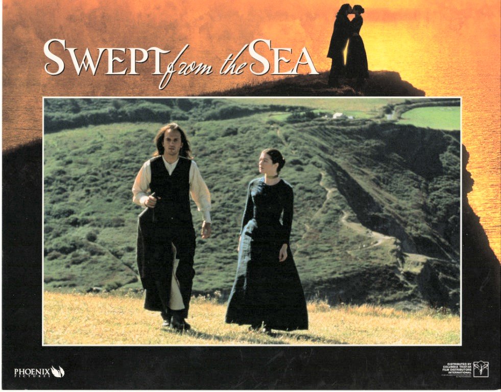 Movie poster for Swept from the Sea: a man and woman in dark period clothing walk across a grassy hillside at sunset.