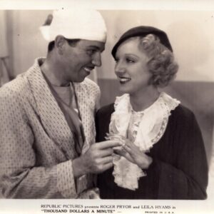 Vintage film still from Republic Pictures starring Roger Pryor and Leila Hyams: a man in a robe and a woman in period clothing share a smile while exchanging rings.