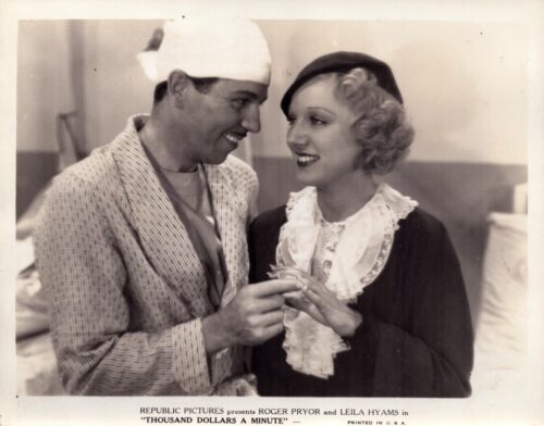 Vintage film still from Republic Pictures starring Roger Pryor and Leila Hyams: a man in a robe and a woman in period clothing share a smile while exchanging rings.