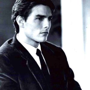 Black-and-white portrait of a serious man in a suit, looking to the right, with a focused expression.