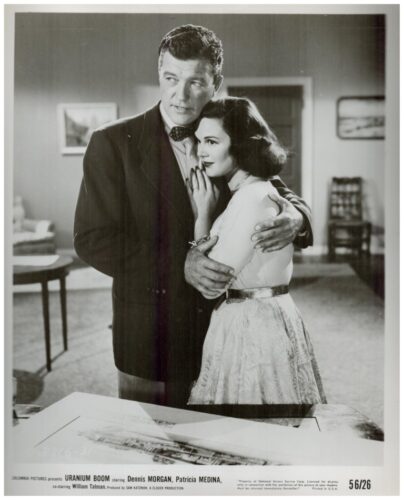 Black-and-white movie poster for Uranium Boom featuring a man and a woman embracing indoors; captioned with cast Dennis Morgan and Patricia Medina.