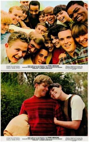 Group of diverse young friends smiling and leaning in for a group selfie indoors.