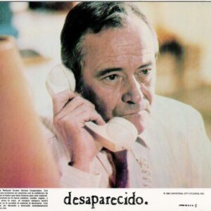 Older man on a landline phone, looking worried, as part of a poster for Desaparecido.