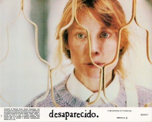 Portrait of a woman seen through a lattice barrier; the bottom shows the Spanish word 'desaparecido' (missing).