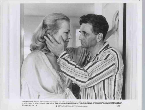 Man gently holds a woman’s face as they gaze at each other in a doorway, conveying an intimate moment
