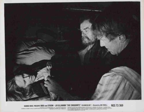 Black-and-white film still: two men leaning over a woman lying down in a dark, intimate scene from a poster.