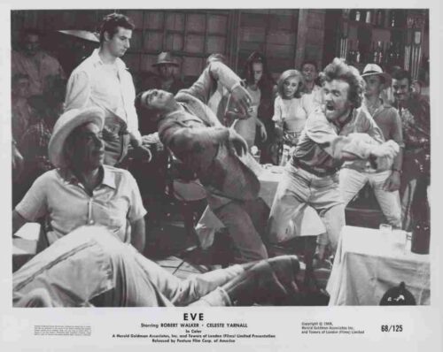 Black-and-white scene of a bar brawl: a man punches another as a crowd watches intensely.