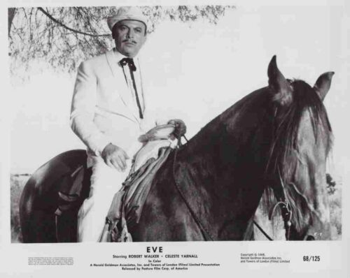 Promotional still from the film Eve: a man in a white suit on a dark horse wearing a hat.
