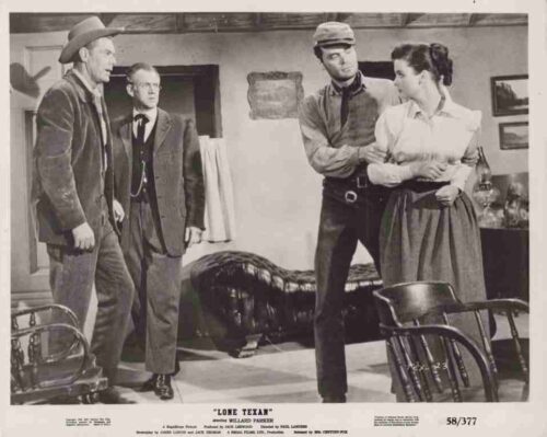 Black-and-white still from Lone Texan: a cowboy on the left, an older man in the center, and a soldier restraining a woman in a living room setting.